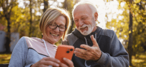 Happy couple connecting on hearing loss on a park bench